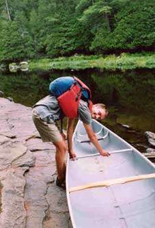 In lifting position to get the canoe up, with extra padding for the shoulders