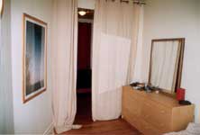 The bedroom with mirror and curtains