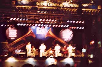 A blurry picture of four guys in white suits at the Jazz Festival.